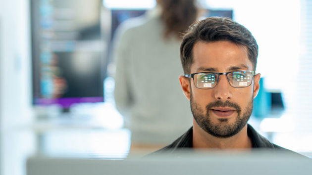 Professional Reviewing Data On Screen 
