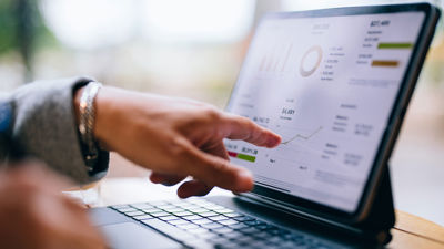 Close Up Of Finger Pointing To Pricing On Tablet 