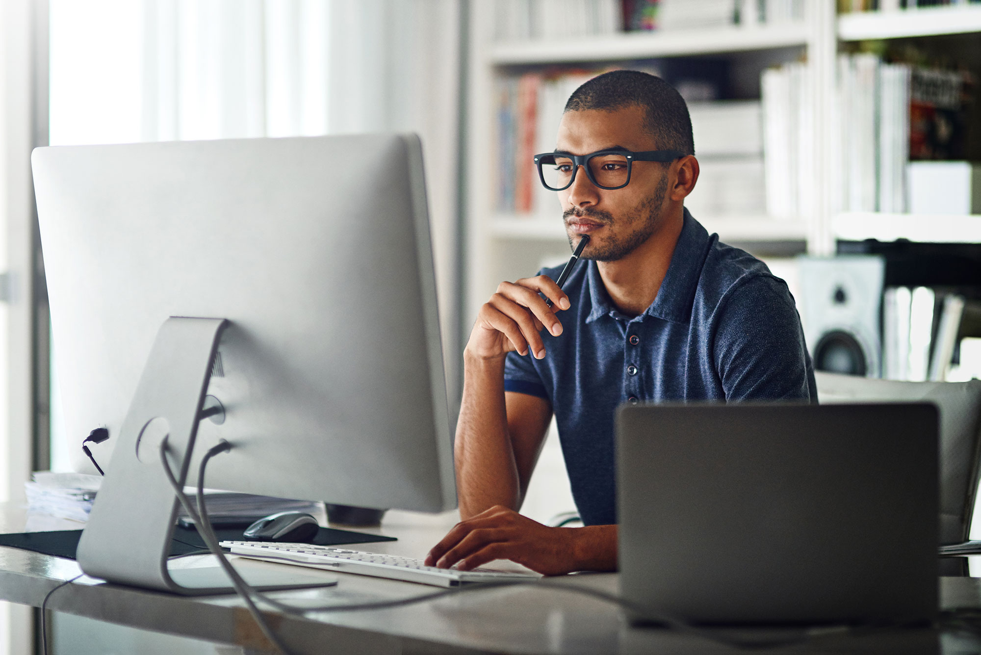 Person Concentrating On Desktop Screen 