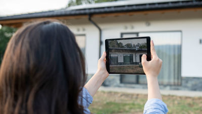 Taking Photo Of Home Exterior On Tablet 