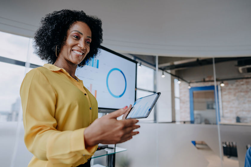 Worker Presenting Tablet In Conference Room 