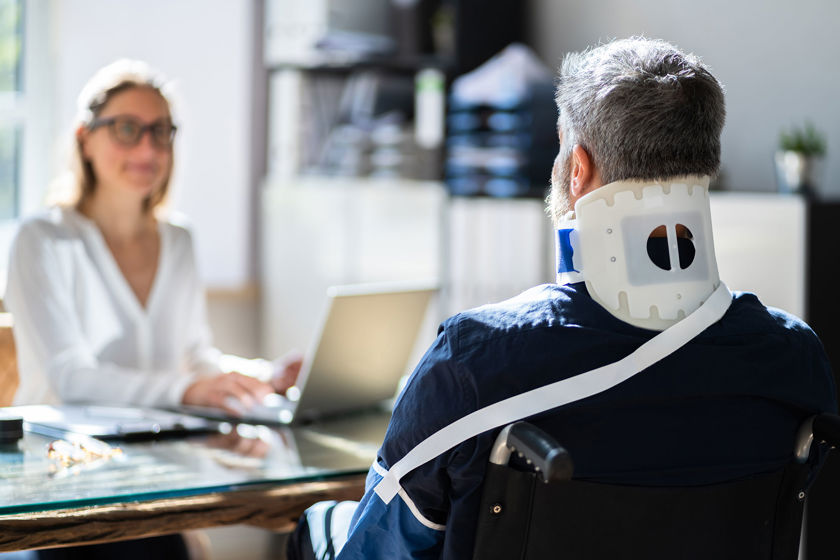 Person With Neck Brace Speaking To Medical Professional 