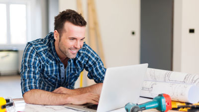 Contractor On Laptop At Jobsite 