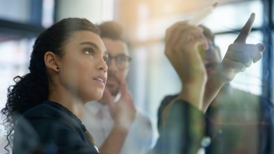 Woman With Focused Look At Whiteboard 