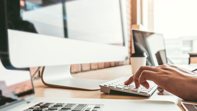 Close Up Of Hands Working At Keyboard 