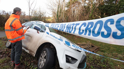 Adjuster Reviewing Car Accident Damage With Tablet 