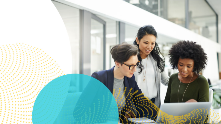 Women review work on a laptop