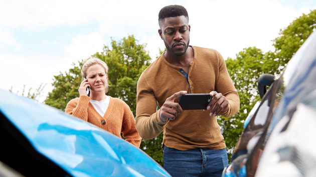 Man Taking Photo Of Car Accident 