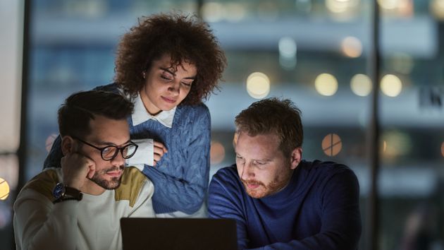 Colleagues Looking At Laptop 