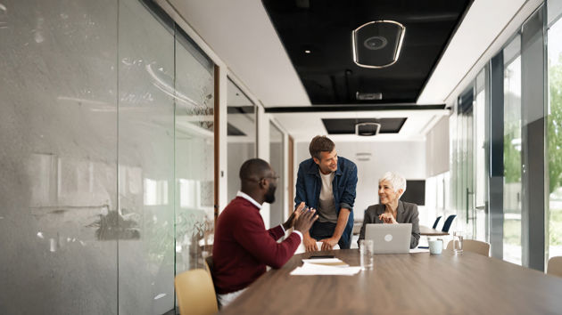 Coworkers Talking Sitting At Table 