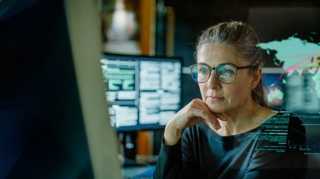 Woman Reviewing Data On Screen Overlay4 