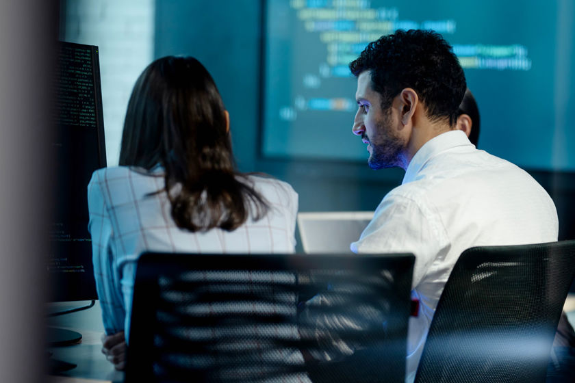 Coworkers Reviewing Data In Room 