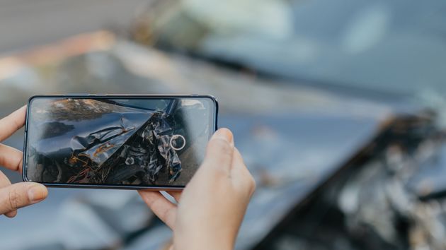 Phone Taking Photo Of Vehicle Damage 