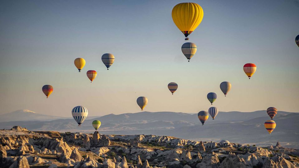 Hot Air Ballons Over Mountain Range 