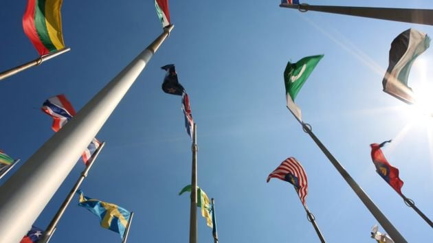 Country Flags Against A Sunny Blue Sky 