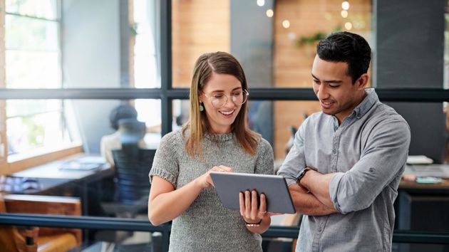 Two Coworkers Reviewing Tablet 