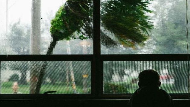 South Korea Typhoon Child Looking Out Window 