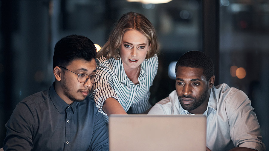 Group Of Coworkers Reviewing Laptop Screen 