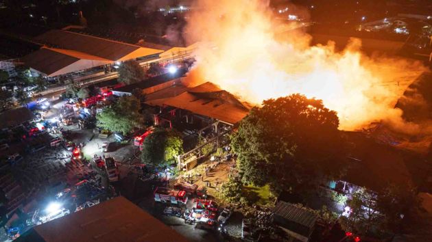 Emergency Personnel At Scene Of Large Fire 