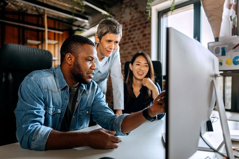 Coworkers Reviewing Information On Screen 