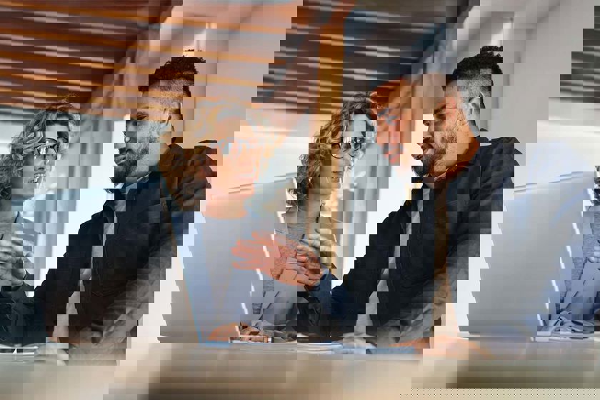 Man Explaining To Coworker 