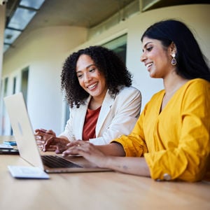 Colleagues Reviewing Laptop Screen 