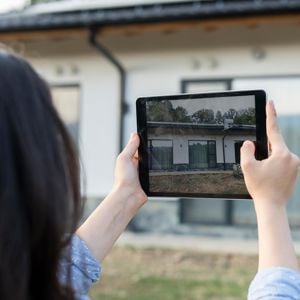 Adjuster Taking Photos On Tablet 
