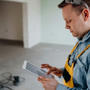 Contractor Using Tablet On Job Site 